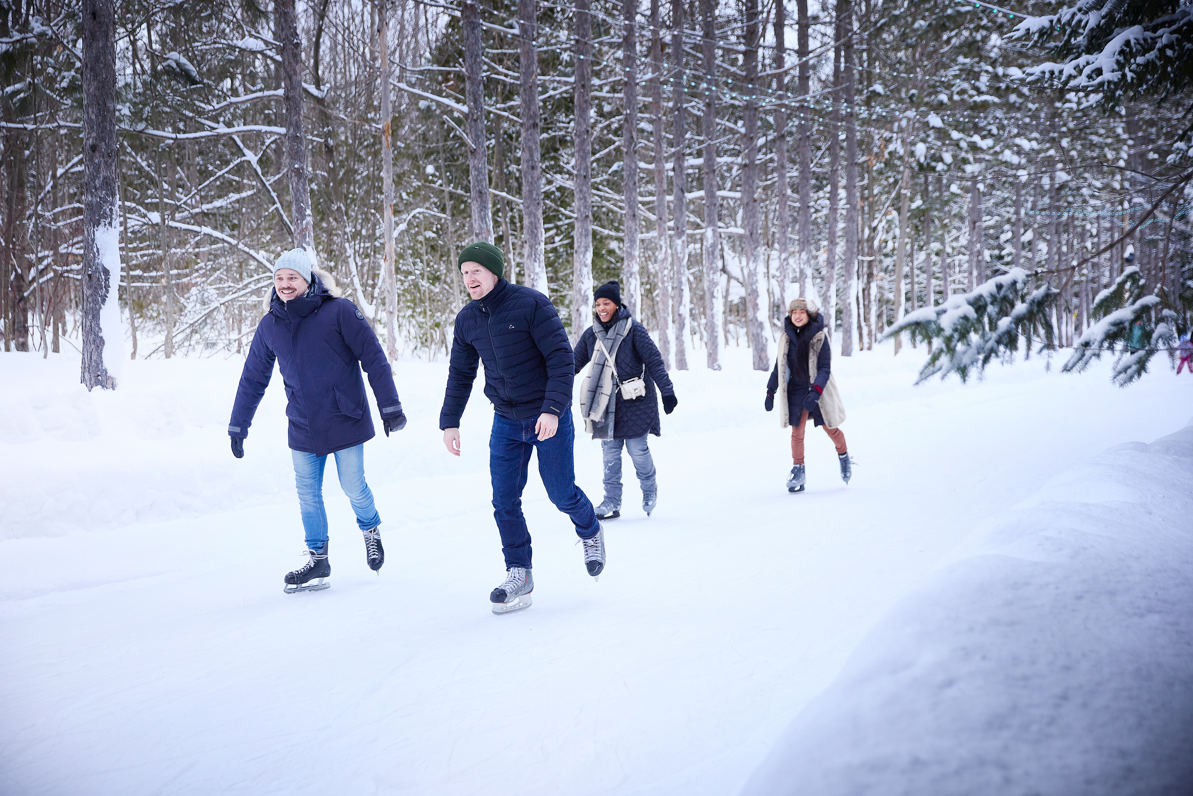Group of friends gliding together along the Woodview Mountain Top skating loop on a Winter afternoon.