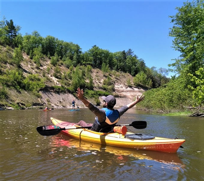 A man kayaking down a river with Free Spirit Tours.