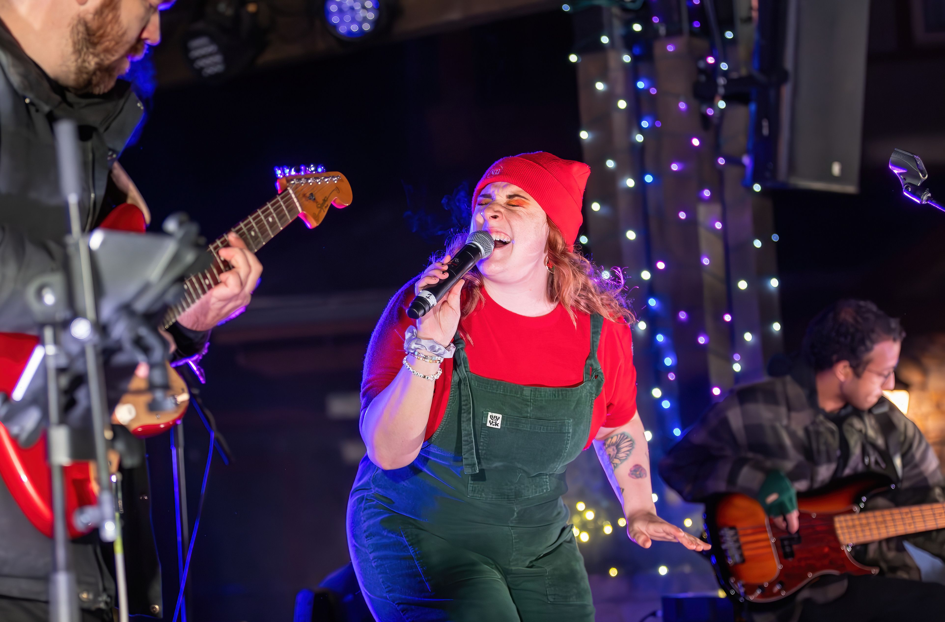 Closeup shot of Holiday Magic Opening Weekend Headliner, Holly Clausius, performing live with her band on the Subaru Stage.