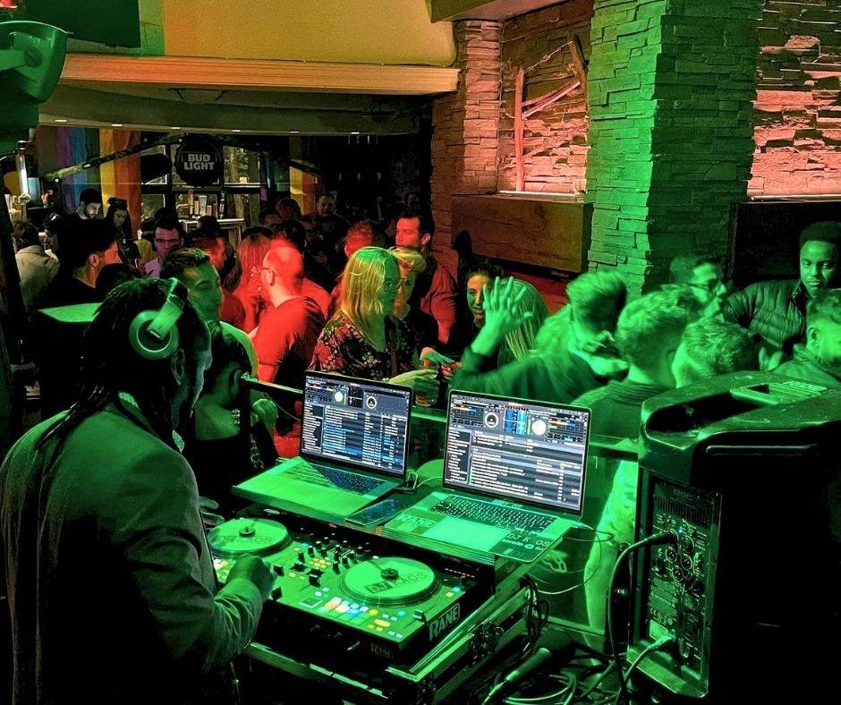 DJ KAOS spinning high-energy beats for a full dancefloor at Kaytoo Restaurant & Bar.