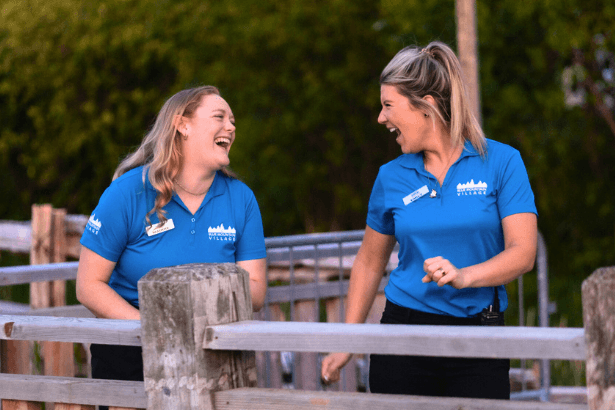 Two BMVA staff walking and laughing, as they stroll down the boardwalk. 
