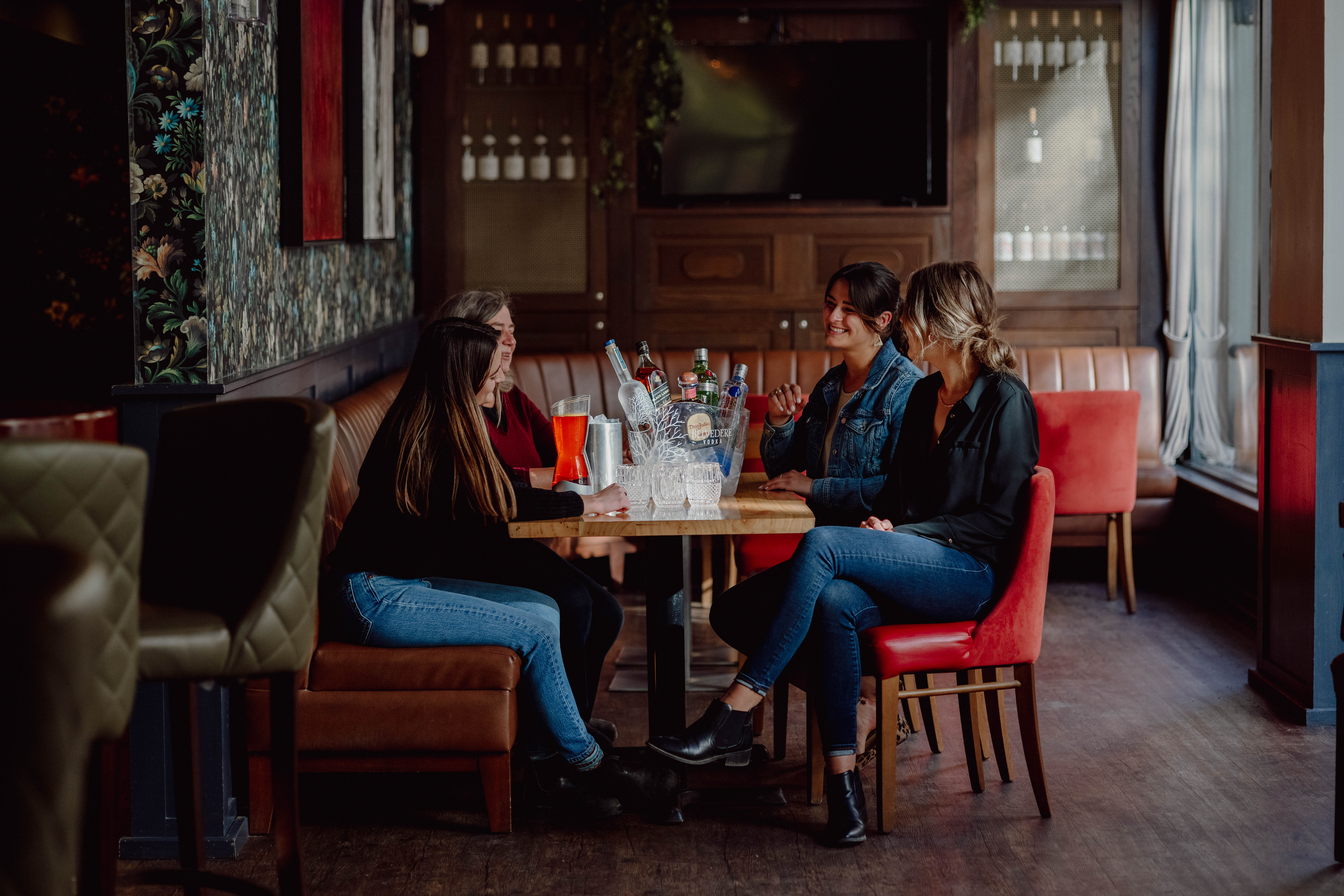 A group of friends enjoy bottle service at Twist Cocktail & Bar. 