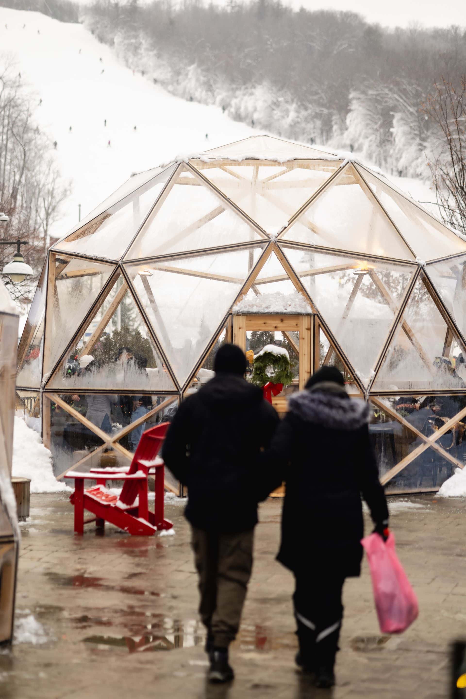 Couple walking towards the Snowdome Cocktail Garden for a midday coffee.