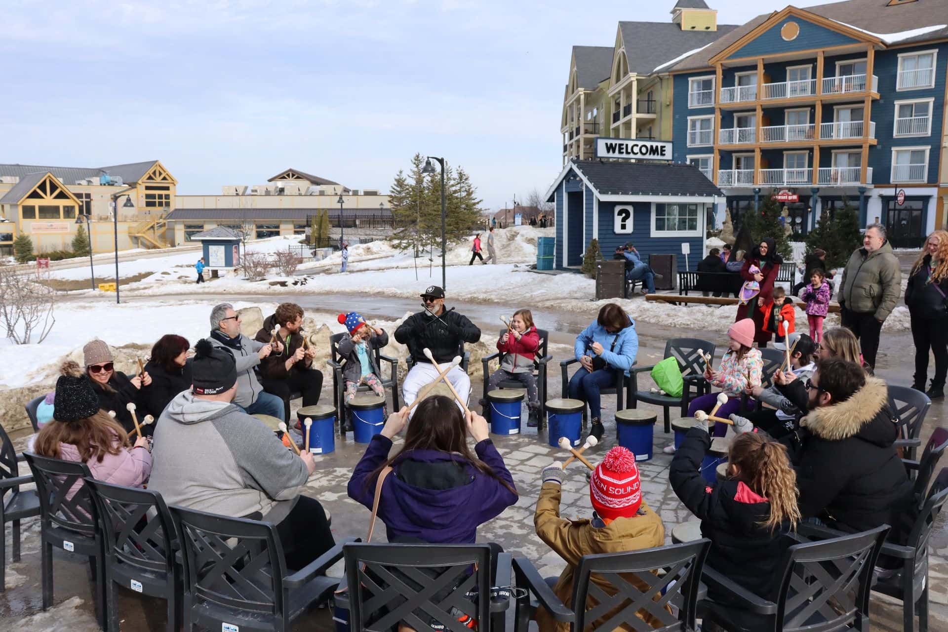 Bamalamb leads a group of all ages in a drum circle during Winter at Blue.