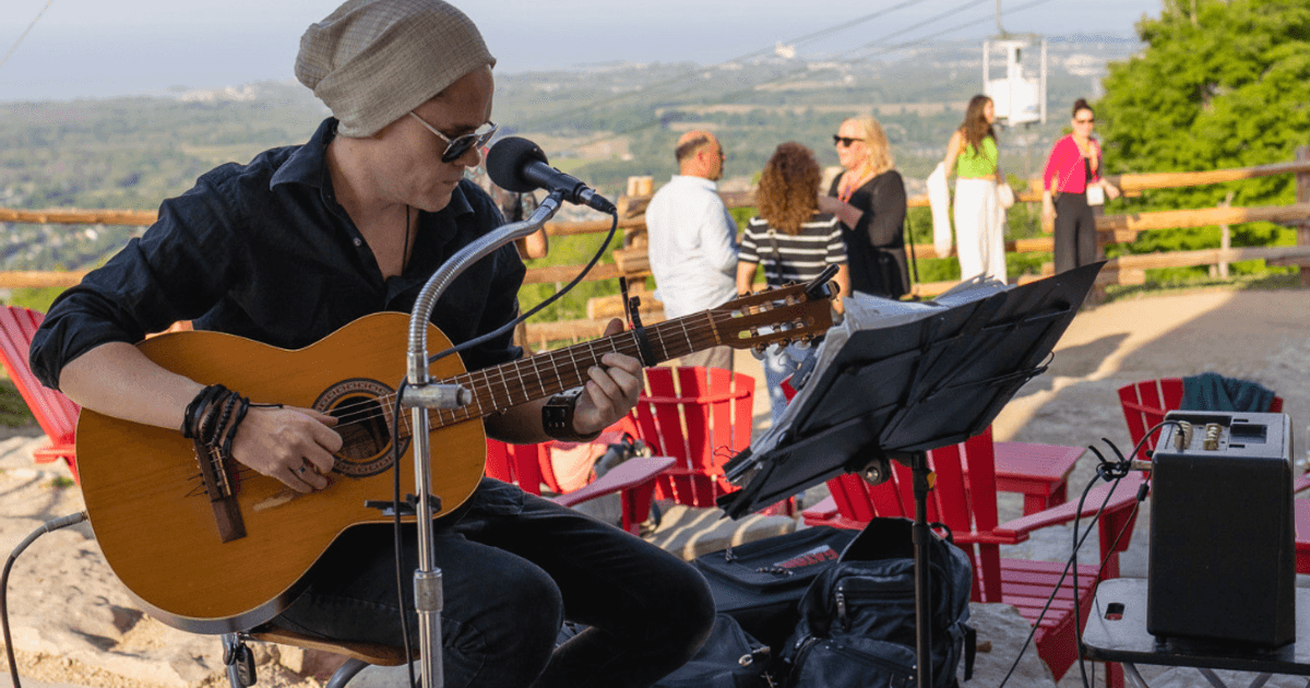 Local artist, Jeremiah Hill, performing and acoustic set during golden hour at Summitview Pavillion on a warm evening at the top of the Mountain.