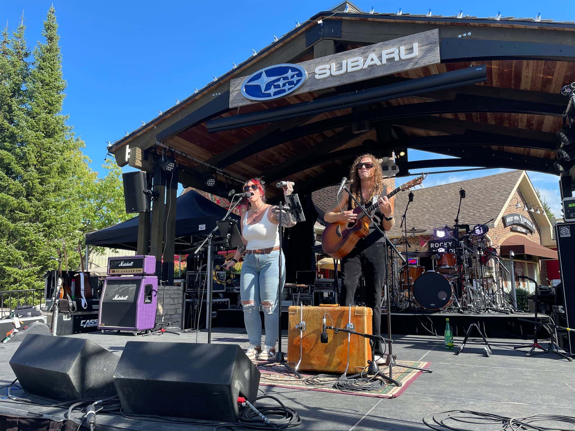 The Jenny Howes Duo performing live on the Subaru Stage on a blue bird day in the Village.