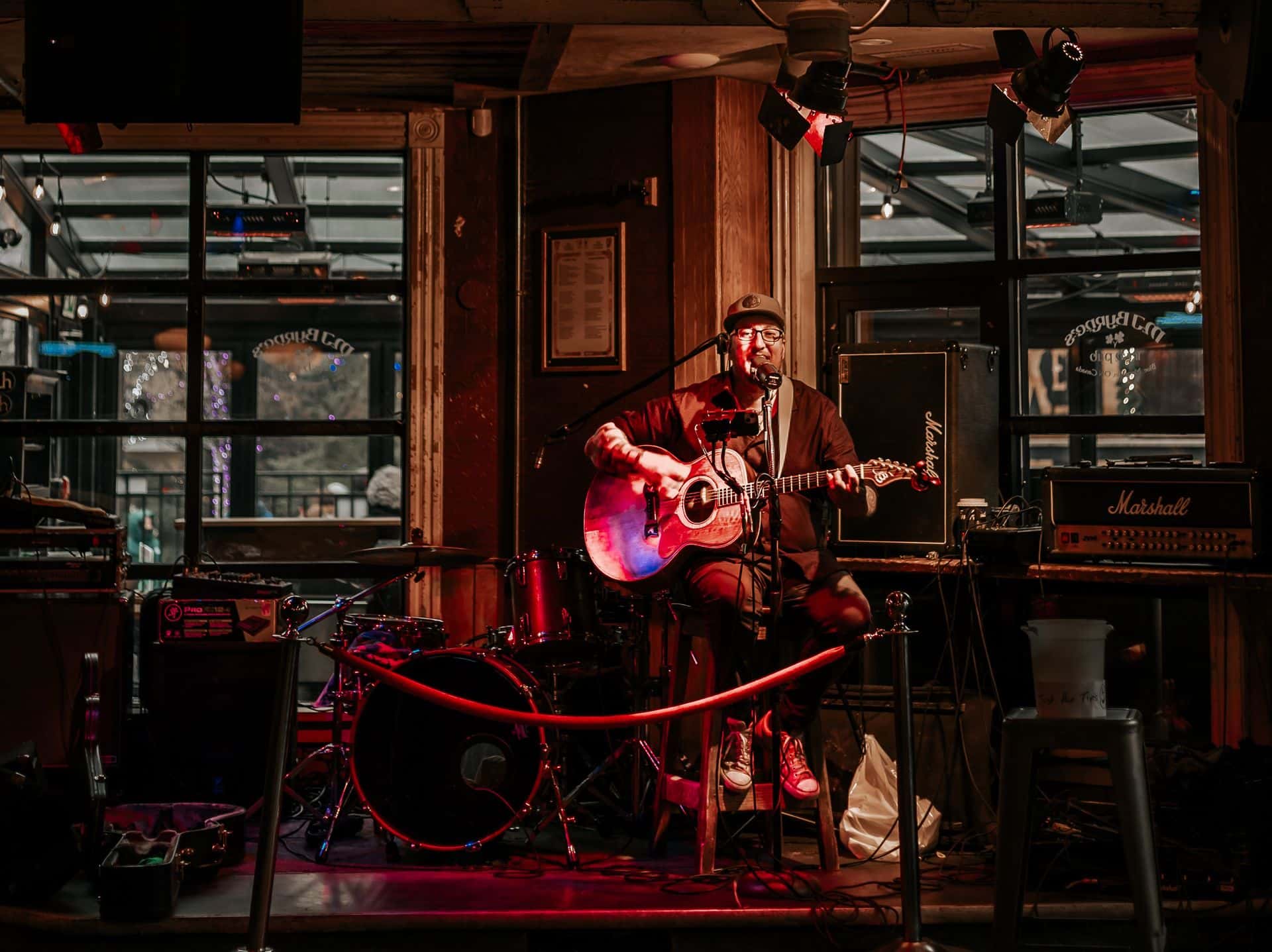 An acoustic solo artist performing live at MJ Byrne's Irish Pub in the Village
