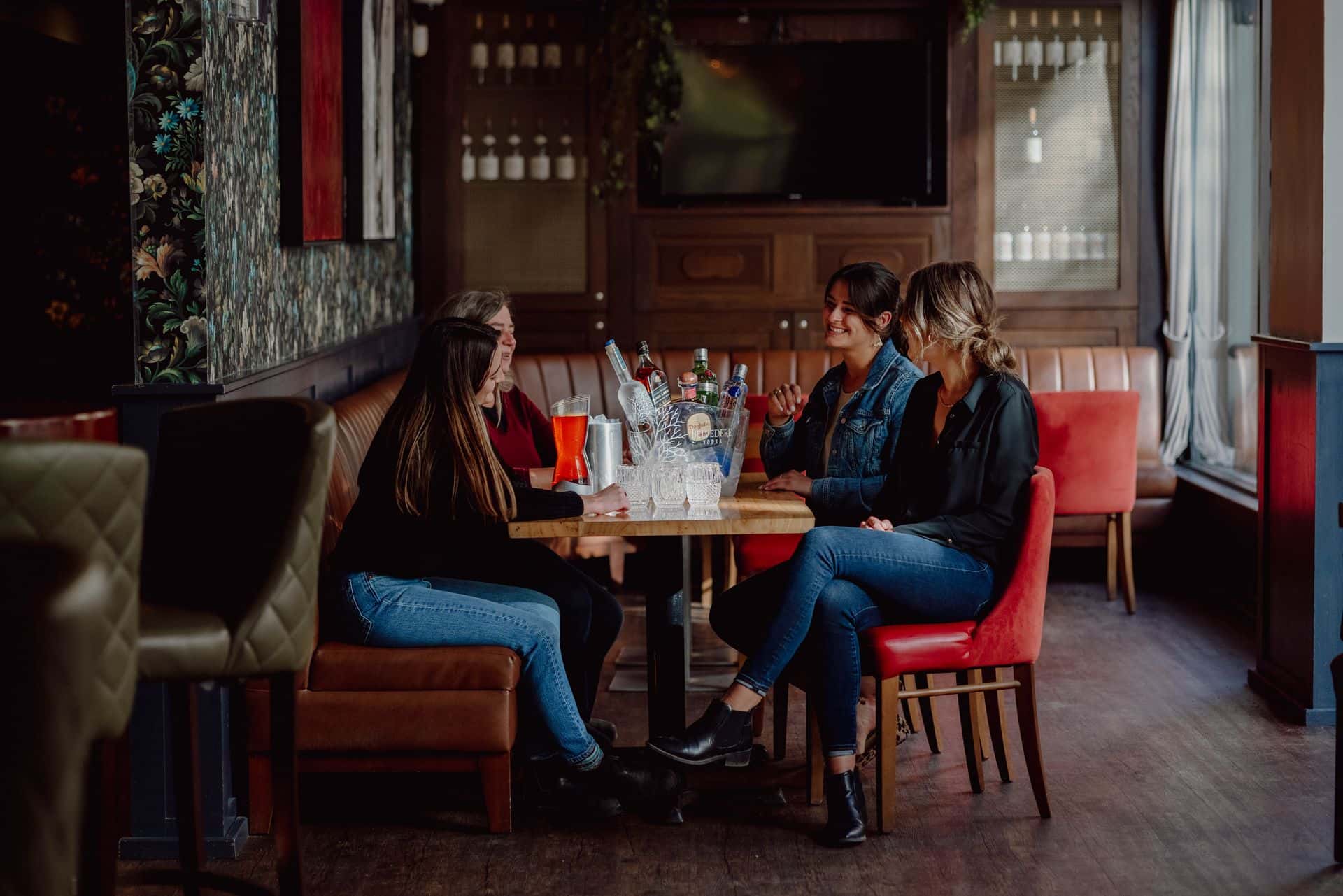A group of friends enjoy bottle service at Twist Cocktail & Bar.