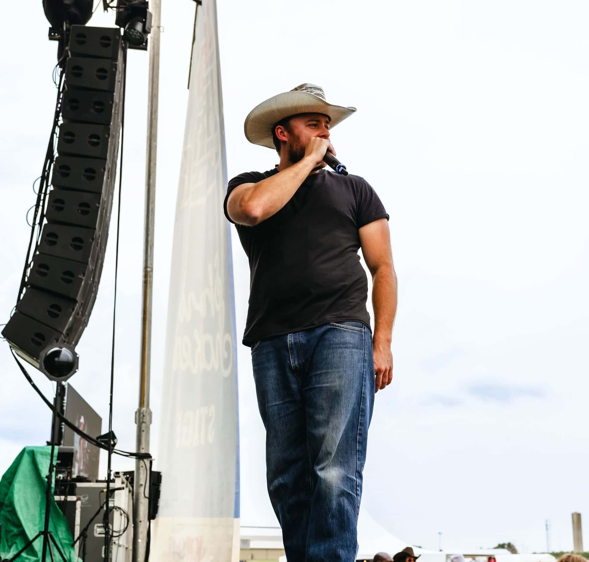 Braydon Cunningham of Urban Cowboy Line Dancing leads a crowd in line dancing lessons from the main stage
