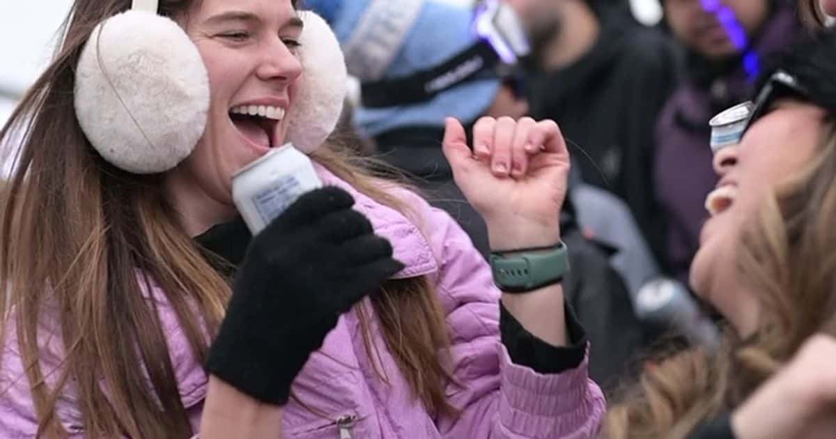 Girls dressed in winter Apres attire, dancing with drinks in hand on Kaytoo's patio during the Aftrglow Festival in 2025