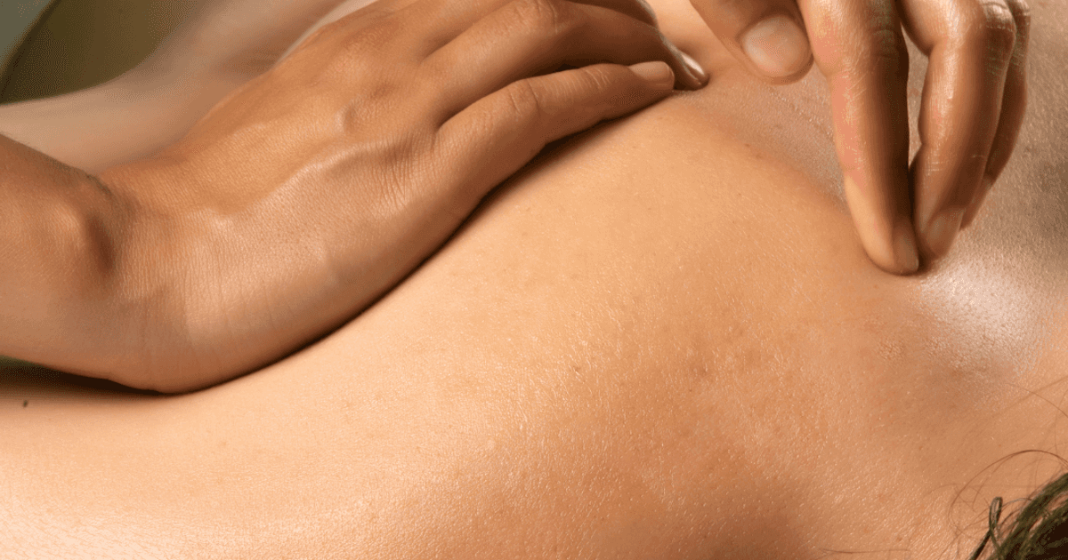 A close up shot of a masseuse giving their client an upper body massage at iwa Spa in the Village.