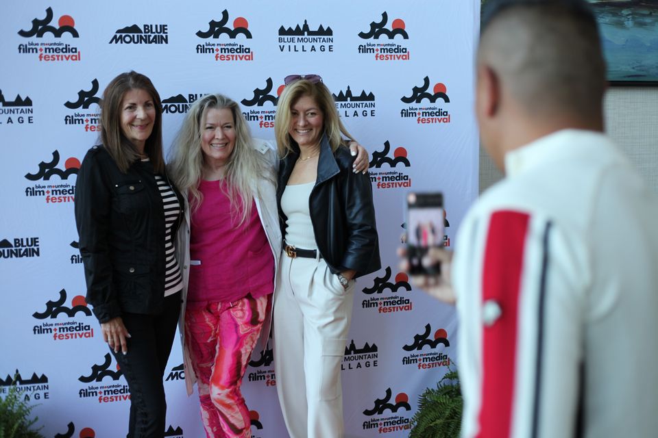 A photo being taken of three ladies attending the Blue Mountain Film + Media Festival.