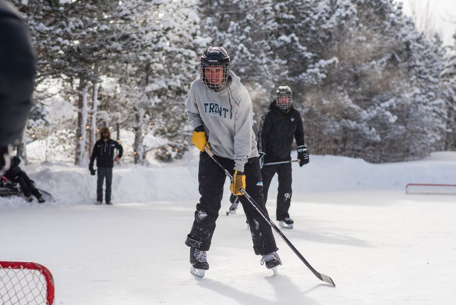 Group of men playing a pick up game of hockey on the mountaintop Shinny Pad.