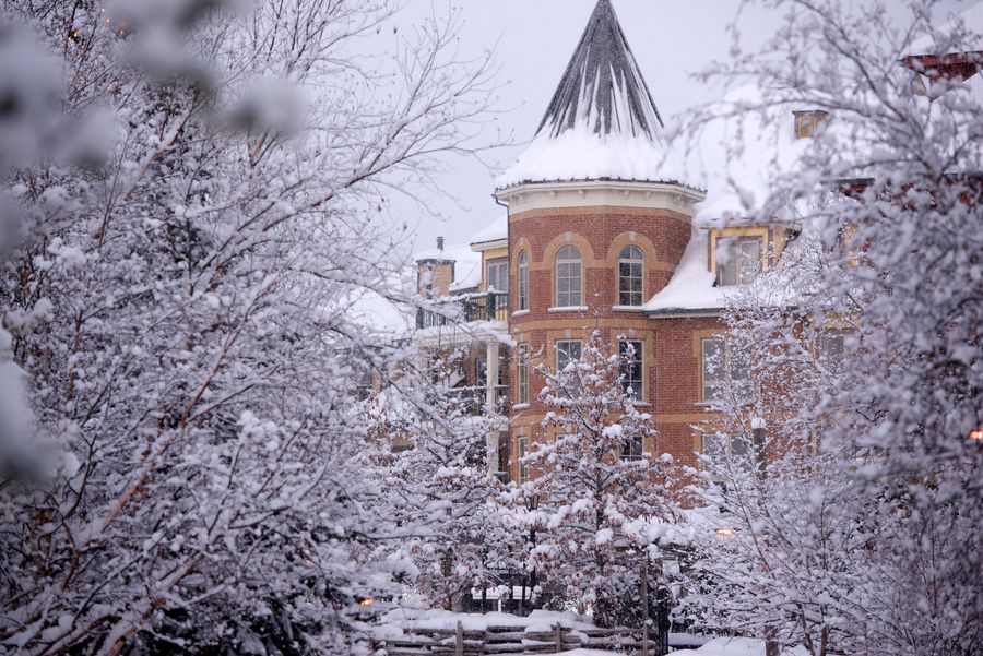 Scenic view of snow covered trees framing the Village Boutique Suites available for lodging.