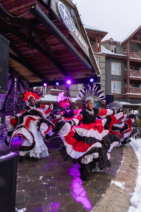 Caribbean Winterfest performers dressed in flamenco dresses, dancing on the Subaru Stage.