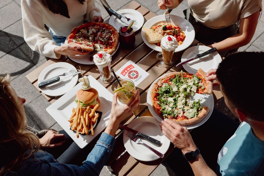 Image from above of a table filled with food delicious from Firehall Pizza. 