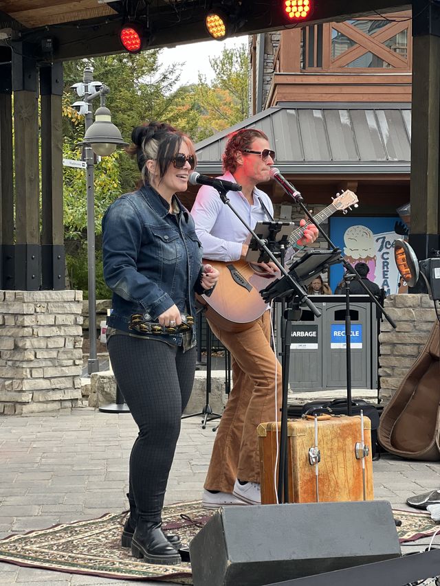 The Jenny Howes Duo performing live on the Subaru Stage on a crisp Fall afternoon at Apple Harvest Festival in the Village.