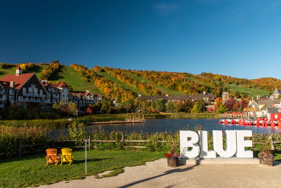 A landscape of photo of the Blue sign on a beautiful fall day. 