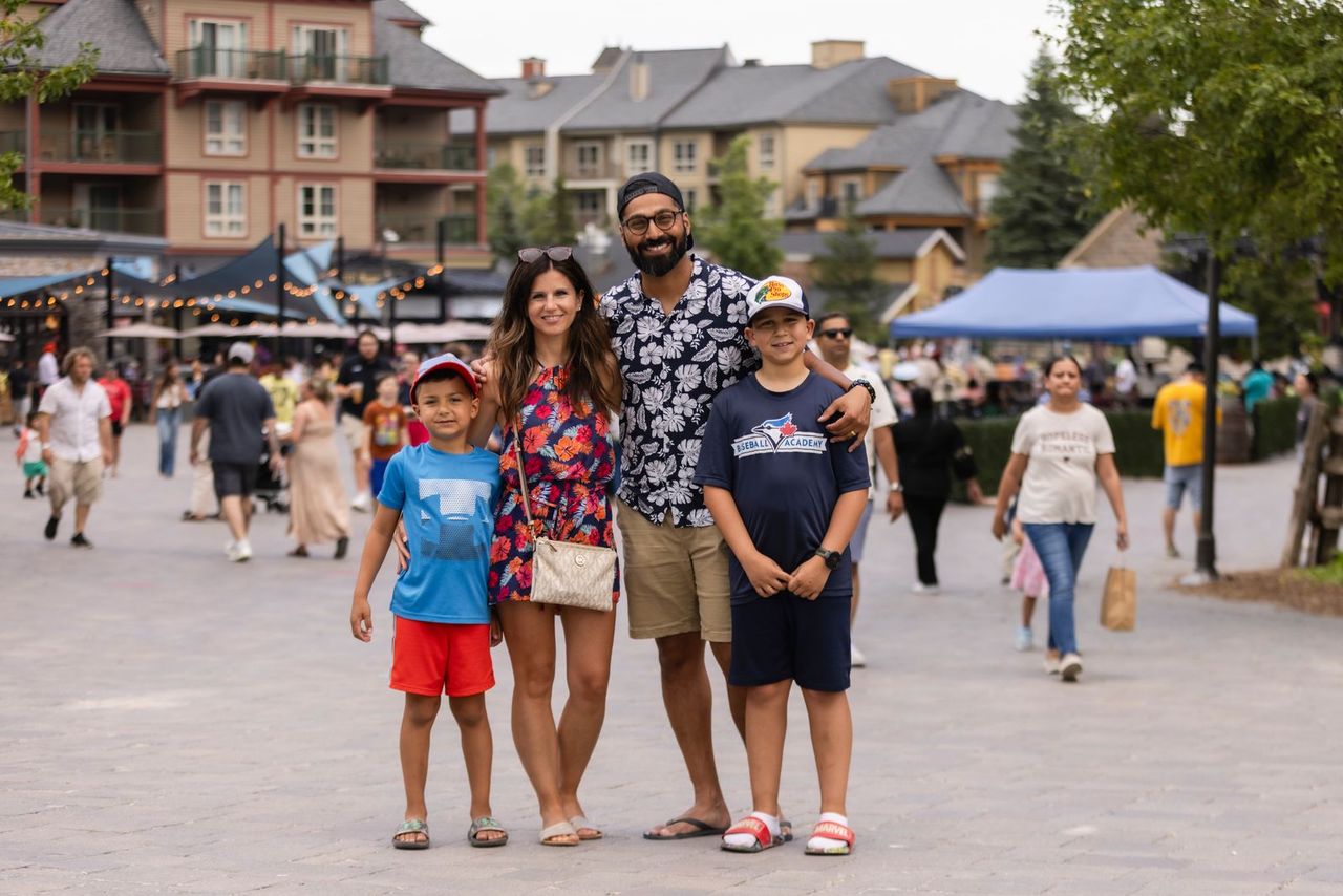 A Family smiles as their photo is taken in teh events plaza.