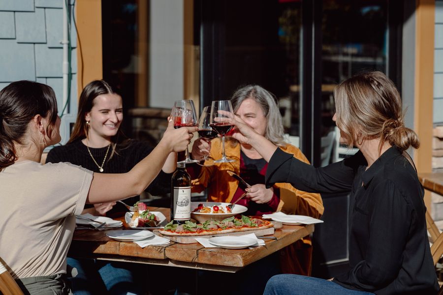 A group of friends eat on Firehalls patio for dinner. 