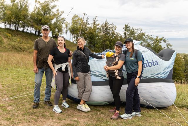 A family taking a photo in front of the giant inflatable Columbia show installed along the Guitar Trail