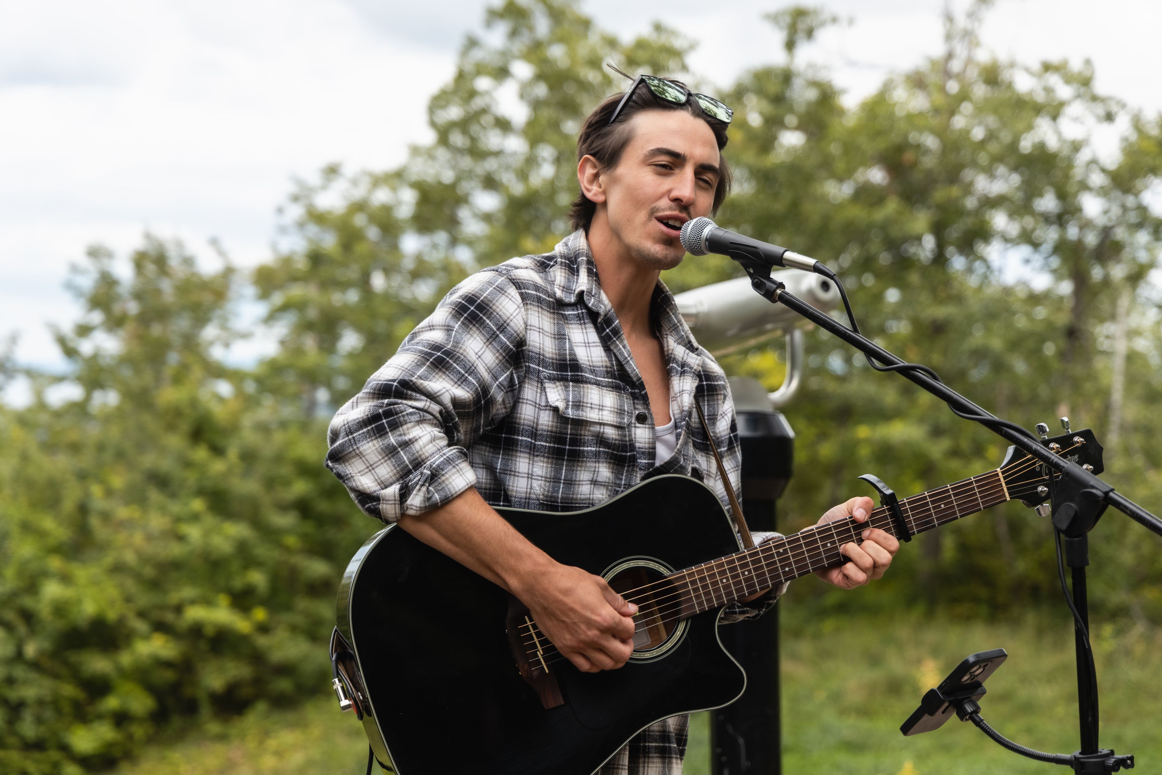 Emerging artist Rogan Rei performing and acoustic set from the Village Way Lookout during Guitar Trail 2025.