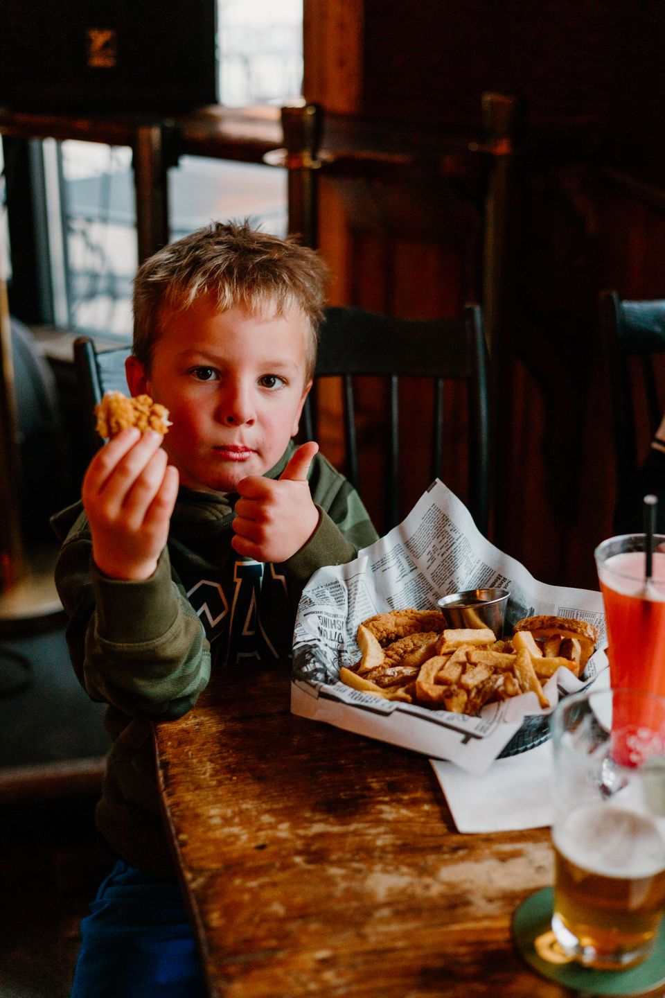 Young boy give a thumbs up to his meal at MJ Byrne's Irish Pub.