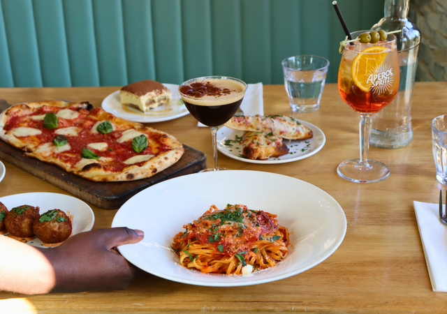 A beautiful table set for four, full of classic italian favourites at Magnones in the Village.