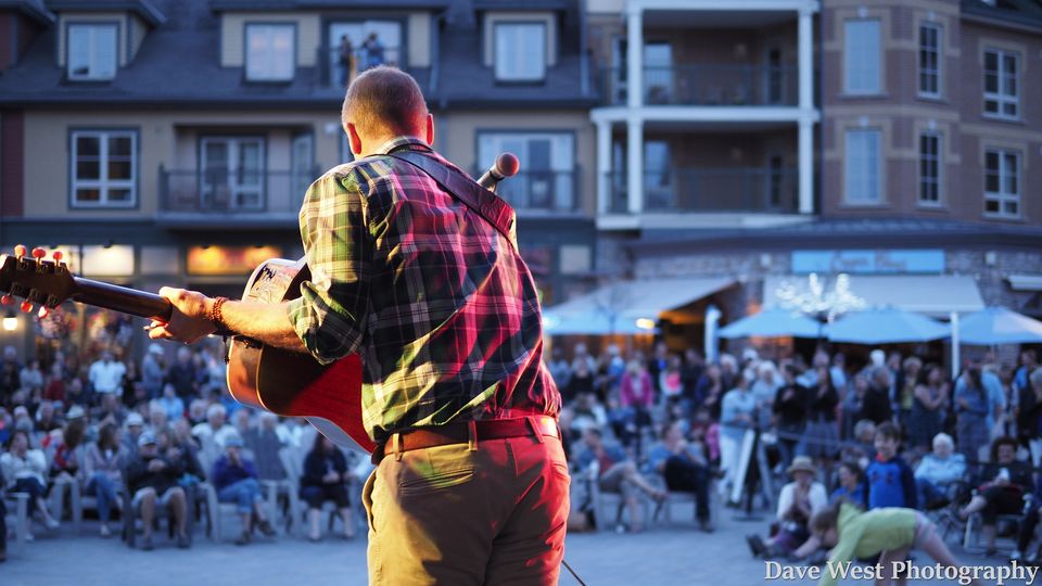 Solo acoustic artist performing live at on the Subaru Stage for Peak to Shore in the Village.