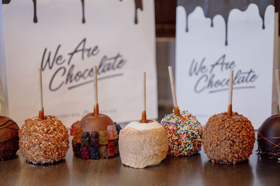 A lineup of chocolate covered candy apples in an assortment of flavour options from Rocky Mountain Chocolate Factory.