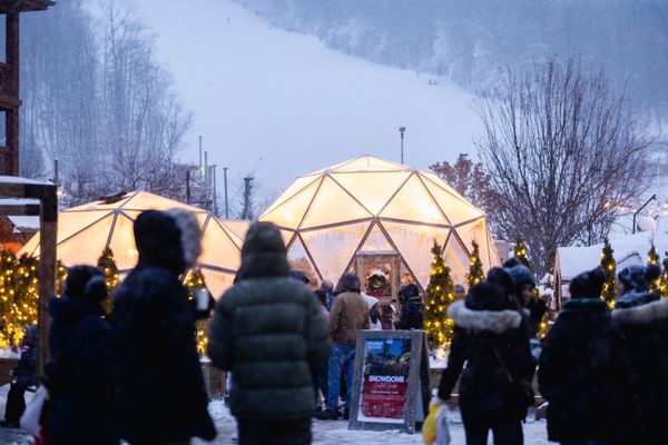 Glowing Snowdomes contrast against the snowy Mountain during early evening in the Village.
