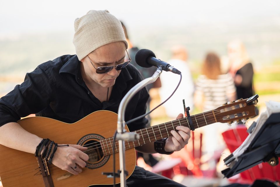 Local artist, Jeremiah Hill, performing and acoustic set during golden hour at Summitview Pavillion on a warm evening at the top of the Mountain.