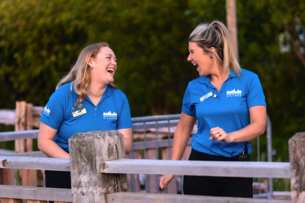 Two BMVA staff walking and laughing, as they stroll down the boardwalk. 