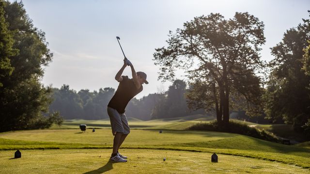 A golfer brings his club up into a full swing as he shoots down the fairway at Monterra Golf Course at Blue Mountain Resort.