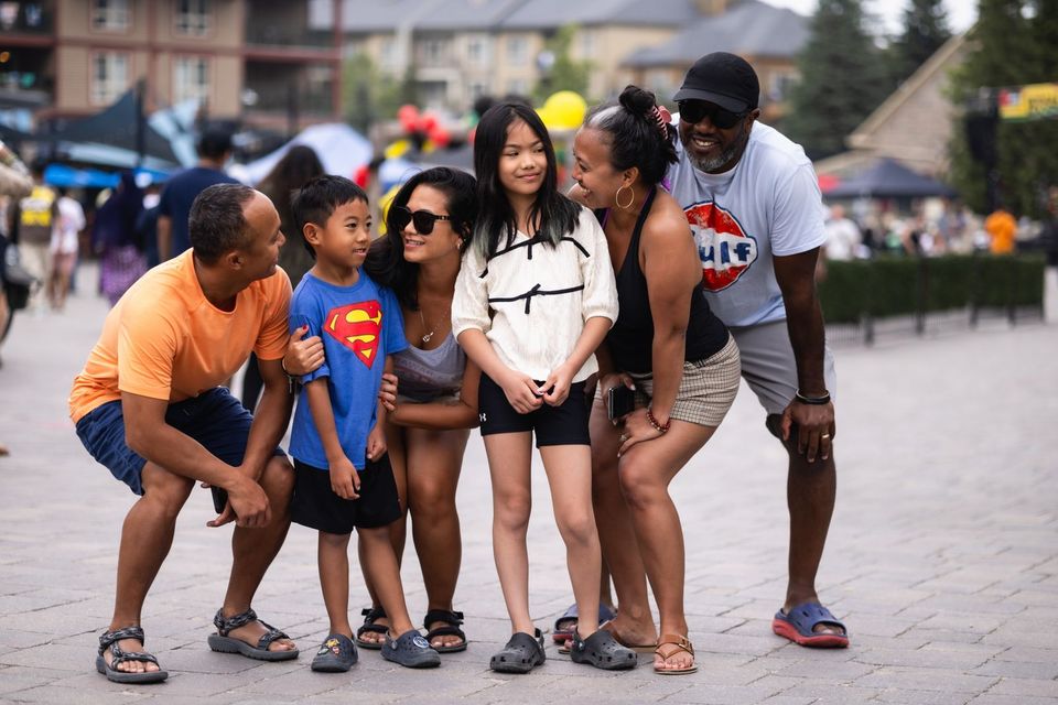 A Family stages for a photo in the events plaza at Reggae on the Mountain.
