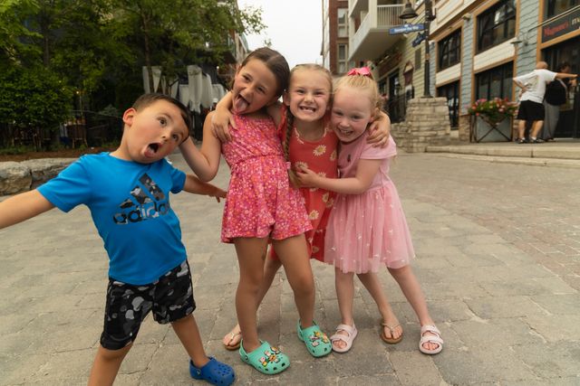 4 young kids making silly faces as they pose for the camera at Blue Mountain Village.