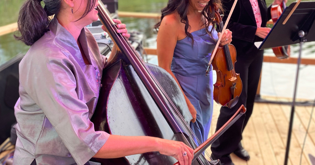 A close up of three members of the Toronto Concert Orchestra performing on the Floating Stage for Symphony on the Pond at Blue Mountain Village.