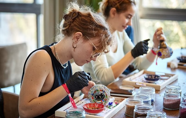 A group of friends creating their own Turkish Mosaic Lamp at Varlin's in-store workshop.