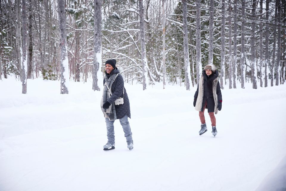 Two girlfriends gliding along the Woodview Mountaintop Skating Loop on a snowy winter afternoon at Blue Mountain Resort.