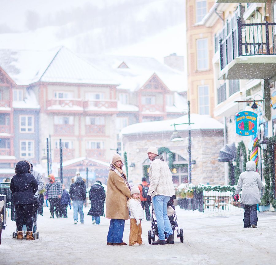 Family walking down Village Crescent on a snowy day.